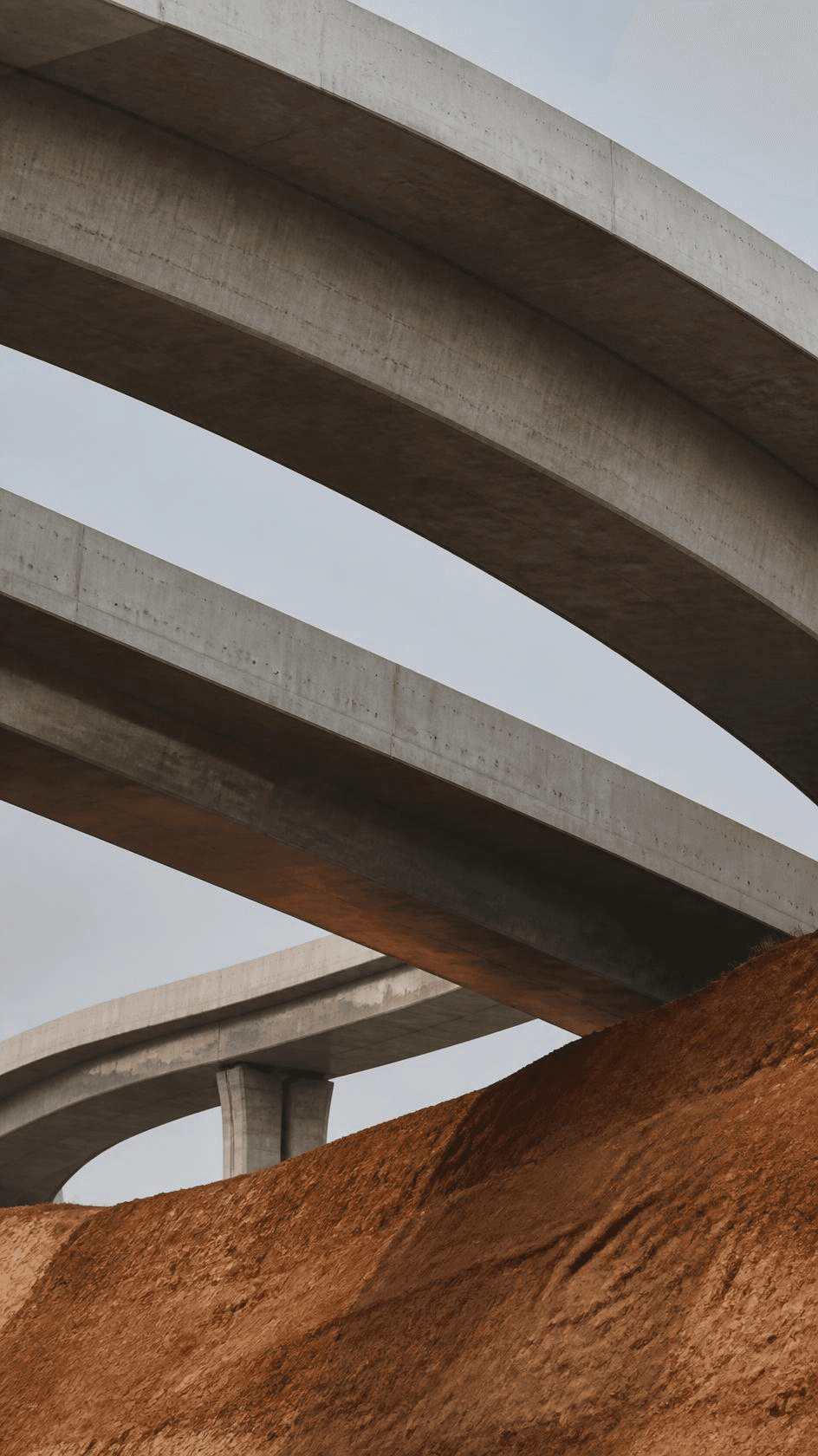 Curved elevated ramps of a highway interchange crossing over one another.