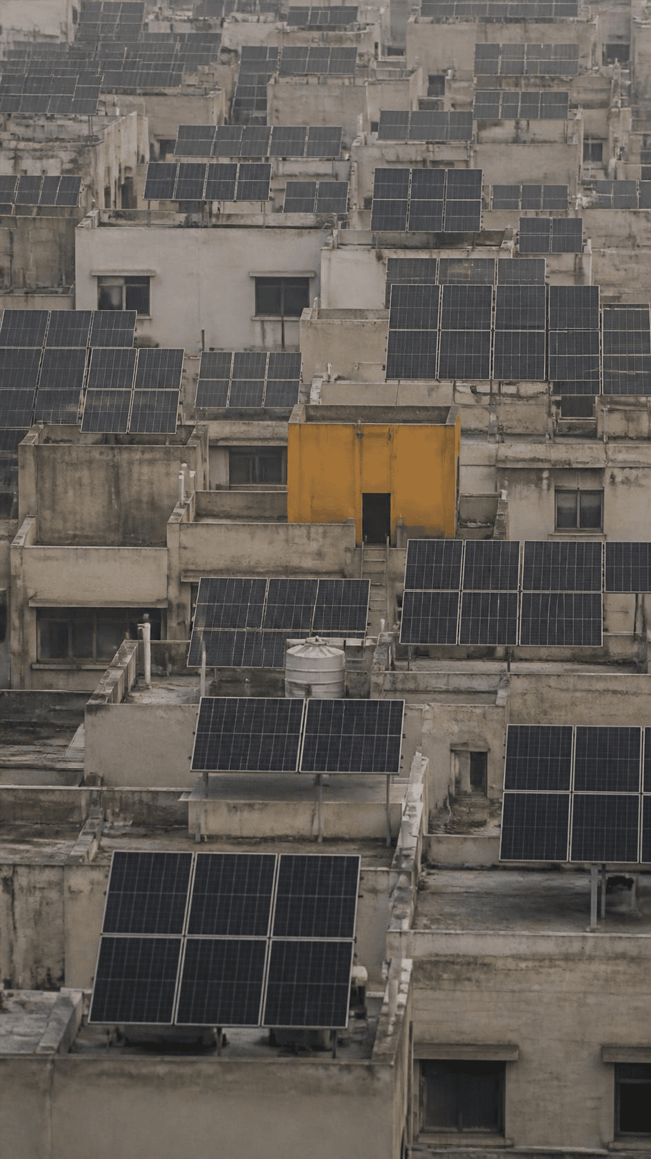 Rooftop solar panels stepping across close-packed low-rise rooftops.