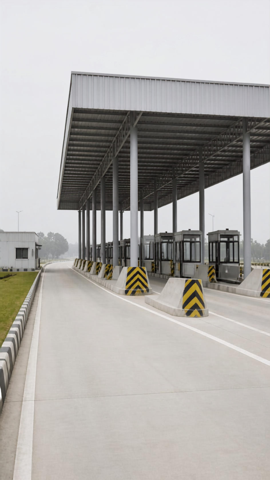 A toll plaza canopy on repeating columns with empty lanes receding into haze.
