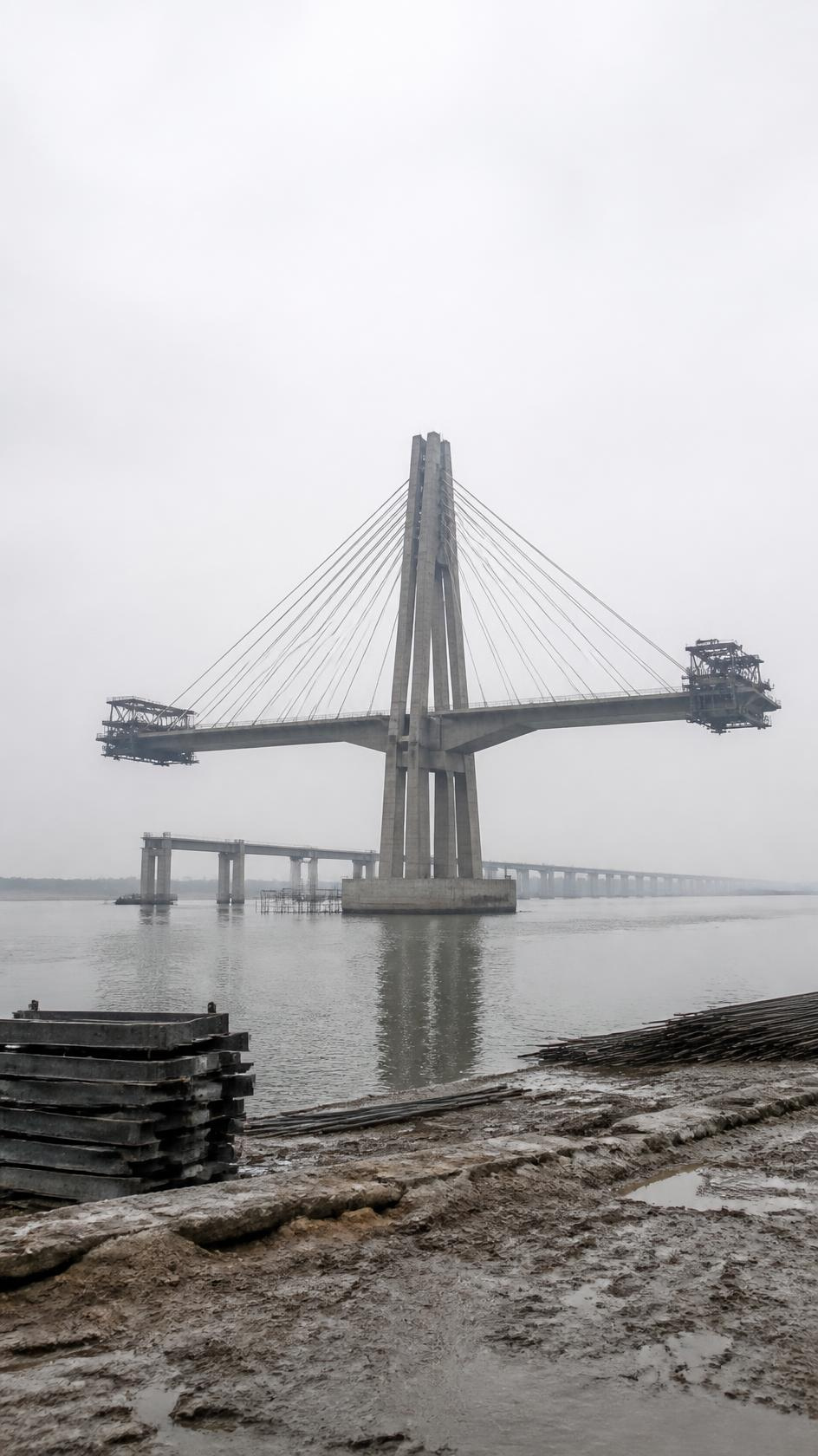Cable-stayed bridge deck built out by balanced cantilever from a river pylon
