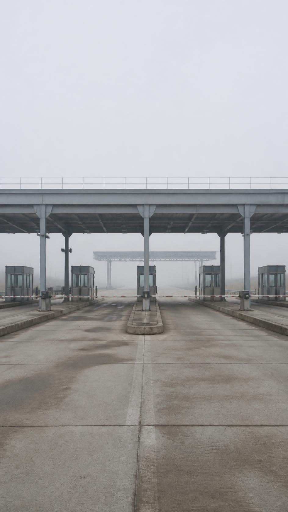 Toll plaza canopy with identical empty lanes and barriers down